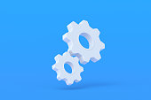 Two gears on blue background. Engineering technology. Mechanism development. Industrial progress. Idea concept. Business cooperation. Teamwork and communication. 3d render