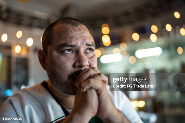mid adult man watching a soccer game at bar - mexico soccer bildbanksfoton och bilder