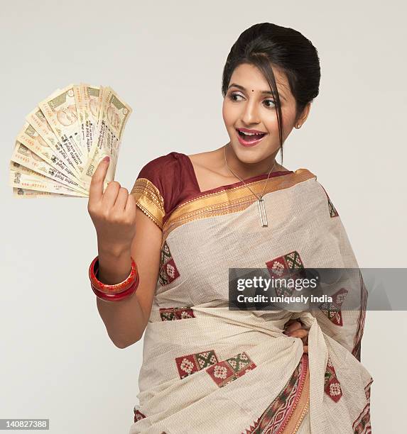 Woman Holding Indian Five Hundred Rupee Notes And Smiling, Photo