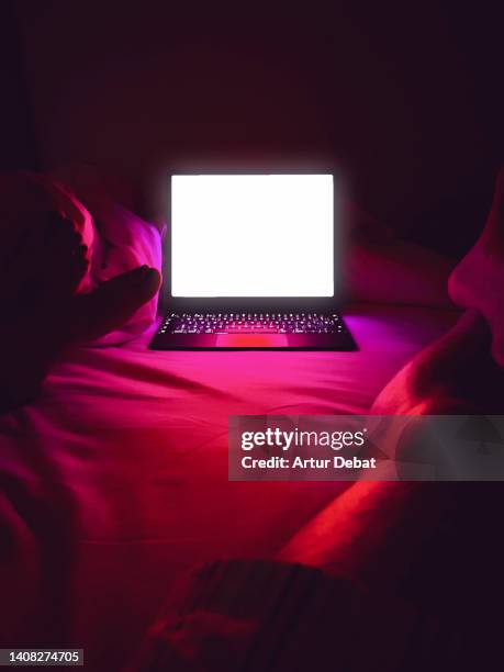 watching series using streaming platform with laptop in the bed at home. - film industry laptop stock pictures, royalty-free photos & images