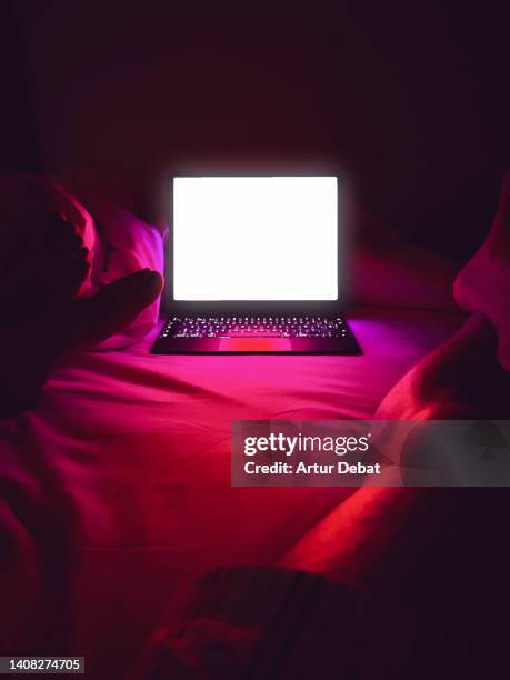 watching series using streaming platform with laptop in the bed at home. - stream stock pictures, royalty-free photos & images