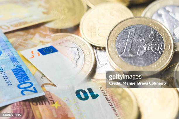 euro paper money and coins - denomination stockfoto's en -beelden
