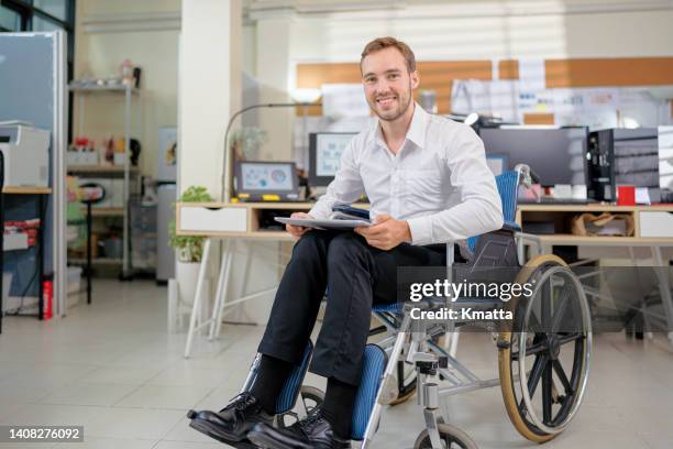 portrait of a confident mid adult businessman with disability sitting on wheelchair holding a digital tablet. - rolling up sleeve stock-fotos und bilder