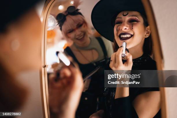 girlfriends doing make-up for halloween party - halloween party imagens e fotografias de stock