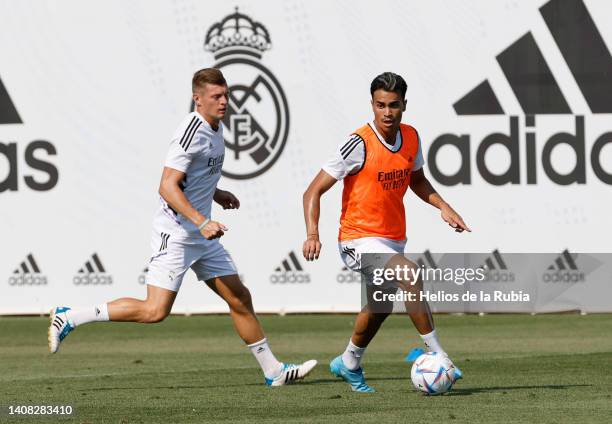 Reinier Jesus Carvalho of Real Madrid is training with teammate Toni Kroos at Valdebebas training ground on July 12, 2022 in Madrid, Spain.