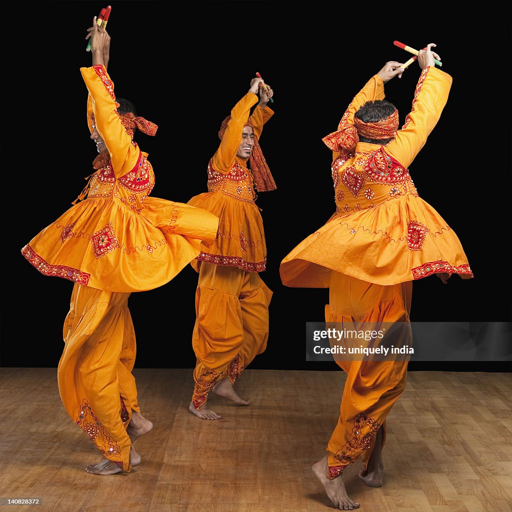 Men performing dandiya