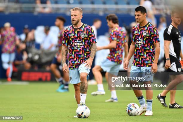 Johnny Russell and Roger Espinoza of Sporting Kansas City in Pride warm up jerseys during a game between New England Revolution and Sporting Kansas...