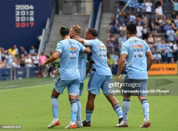 Graham Zusi, Johnny Russell, Logan Ndenbe and Roger Espinoza of Sporting Kansas City celebrate Russells free kick goal in the second half during a...