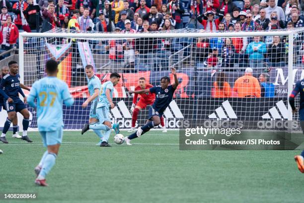 DeJuan Jones of New England Revolution moves to defend against Emanuel Reynoso of Minnesota United during a game between Minnesota United FC and New...