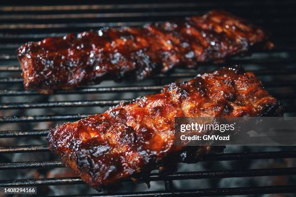 bbq pork spareribs on barbecue grill - barbeque sauce stock pictures, royalty-free photos & images