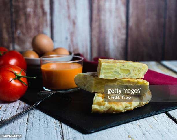 tortilla de patatas, dining room view with detail of all ingredients, copy space, mediterranean food concept. - patatas chips stock pictures, royalty-free photos & images