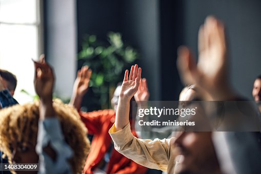 Group of Anonymous People Raising Hands on a Seminar Group of Anonymous People Raising Hands on a Seminar