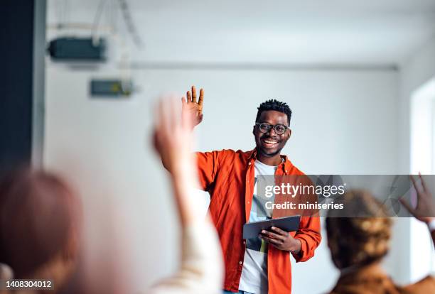 cheerful male presenter interacting with the audience - male volunteer stockfoto's en -beelden