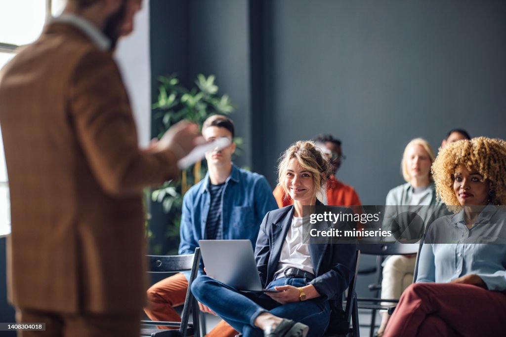 Group of Cheerful People on a Seminar