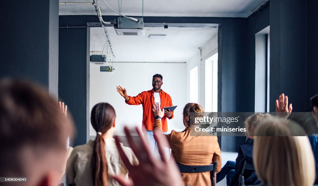 Cheerful Male Presenter Interacting With the Audience
