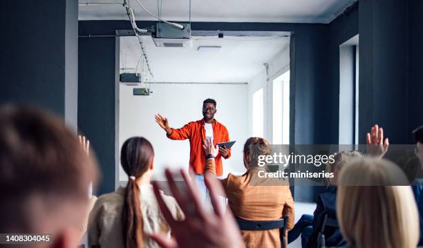 cheerful male presenter interacting with the audience - speakers stock pictures, royalty-free photos & images