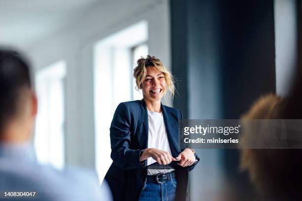 cheerful female presenter interacting with the audience - medium group of people stock pictures, royalty-free photos & images