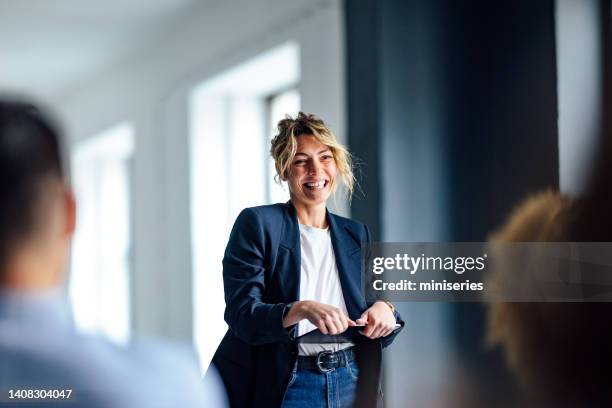 cheerful female presenter interacting with the audience - loudspeaker bildbanksfoton och bilder