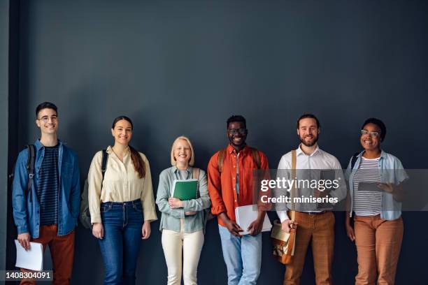 group of students posing for a photo at the university - people in a row stock pictures, royalty-free photos & images