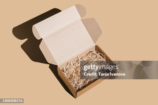 Open blank brown cardboard box on beige background. Open blank brown cardboard box on beige background.