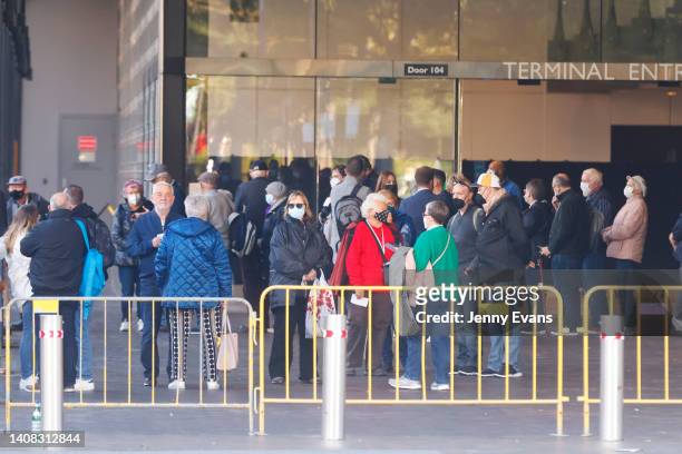 Passengers from the Coral Princess wait to board buses on July 13, 2022 in Sydney, Australia. The Coral Princess, currently experiencing a COVID-19...
