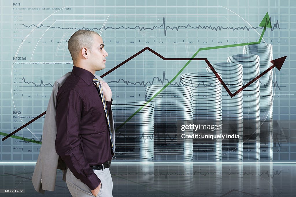 Businessman looking at a line graph