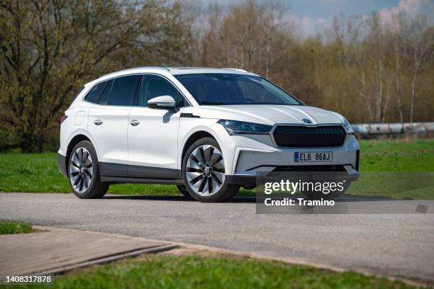electric car skoda enyaq iv on a road - skoda auto stock pictures, royalty-free photos & images