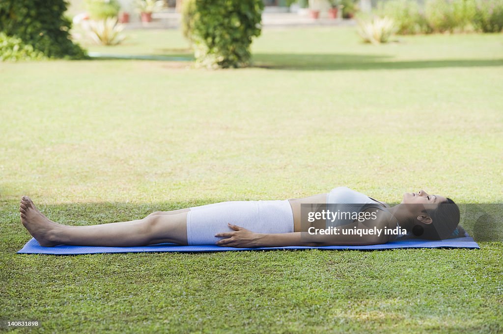 Woman doing Savasana (Corpse Pose)