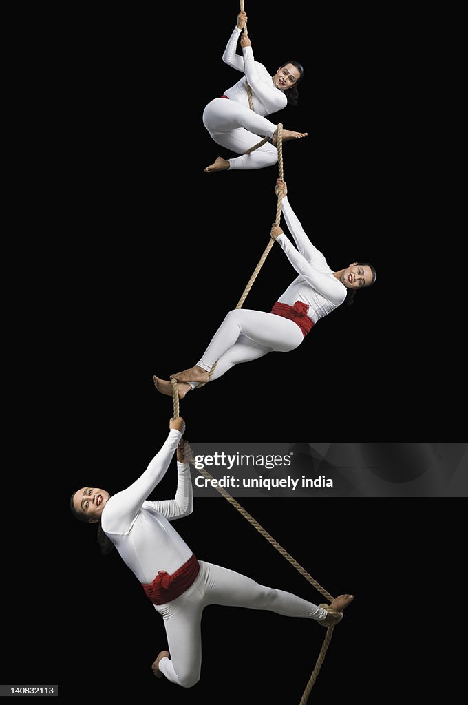 Male acrobats performing on a rope