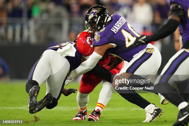 Baltimore Ravens cornerback Brandon Stephens and linebacker Malik Harrison tackle Clyde Edwards-Helaire of the Kansas City Chiefs during an NFL game...