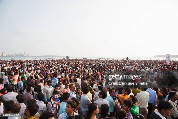 crowd at religious procession during ganpati visarjan ceremony, mumbai, maharashtra, india - mumbai crowd stock pictures, royalty-free photos & images