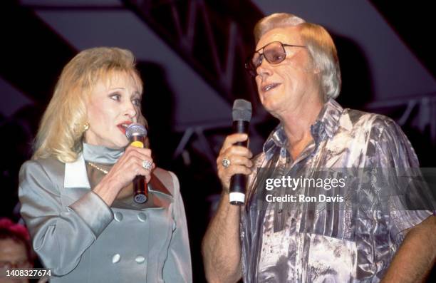 American country music singer-songwriter Tammy Wynette and American musician, singer and songwriter George Jones perform together during a concert...