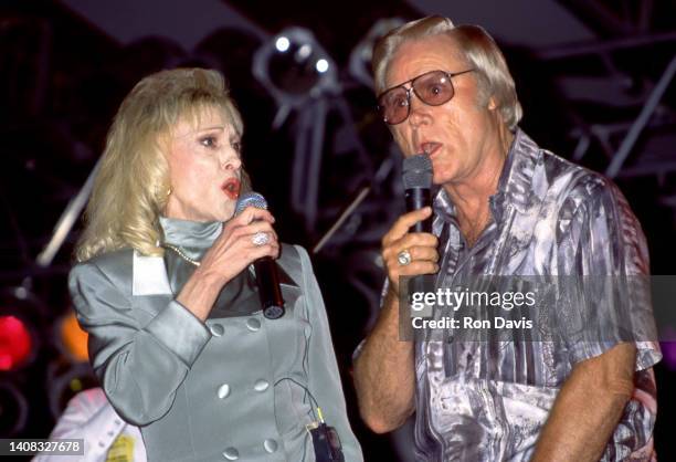 American country music singer-songwriter Tammy Wynette and American musician, singer and songwriter George Jones perform together during a concert...