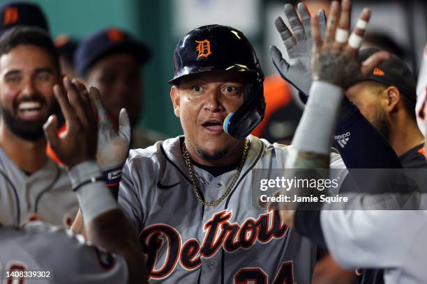 Miguel Cabrera of the Detroit Tigers is congratulated by teammates in the dugout after scoring during the 7th inning of the game against the Kansas...