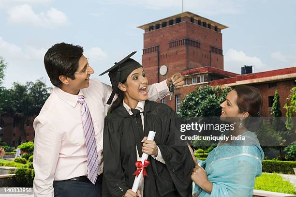 man giving a car key to his daughter after his success - delhi university stock pictures, royalty-free photos & images