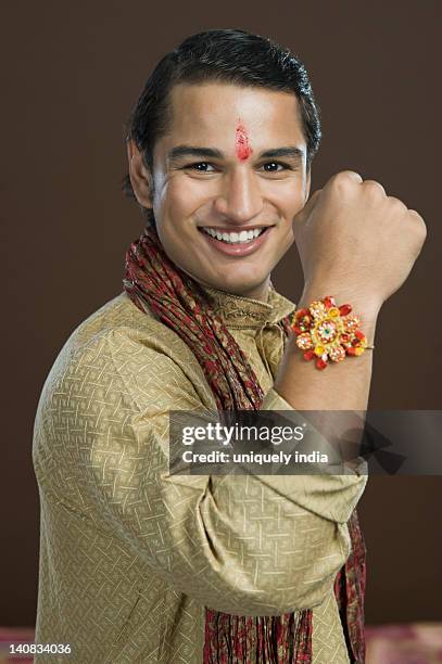 portrait of a man showing his rakhi - rakhi ストックフォトと画像