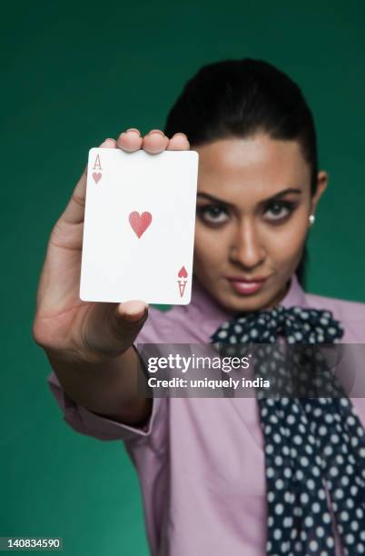 businesswoman showing ace of hearts - purple suit woman stock pictures, royalty-free photos & images