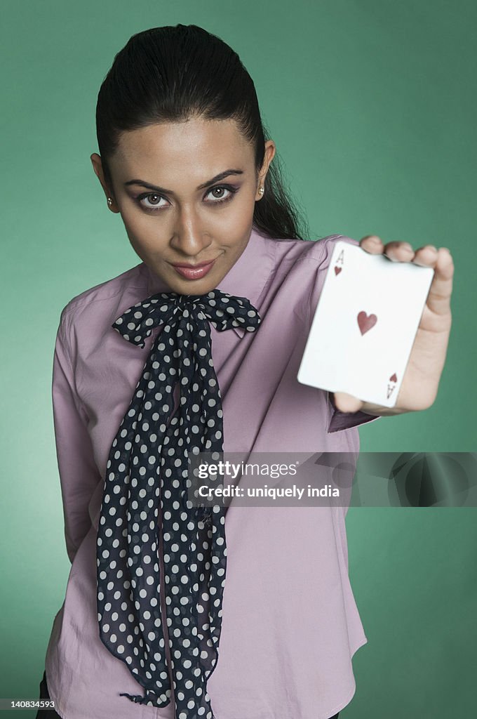 Businesswoman showing ace of hearts