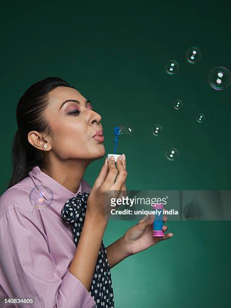 businesswoman blowing bubbles with a bubble wand - sud side company stock pictures, royalty-free photos & images