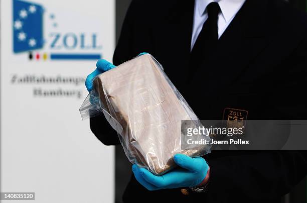 German customs agents shows a package containing confiscated cocaine at a press conference on March 4, 2012 in Hamburg, Germany. Agents seized 260 kg...