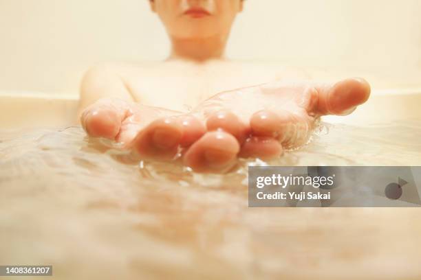 woman in a relaxing bathtub. - japanese women bath stock pictures, royalty-free photos & images