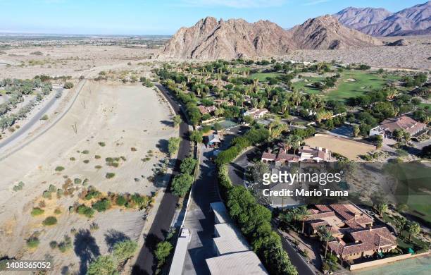 An aerial view of homes and a golf course next to undeveloped desert on July 12, 2022 in La Quinta, California. According to the U.S. Drought...