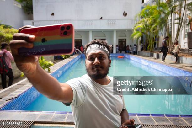 Protester takes a selfie near a swimming pool inside the presidential palace on July 13, 2022 in Colombo, Sri Lanka. Sri Lanka’s airforce has...