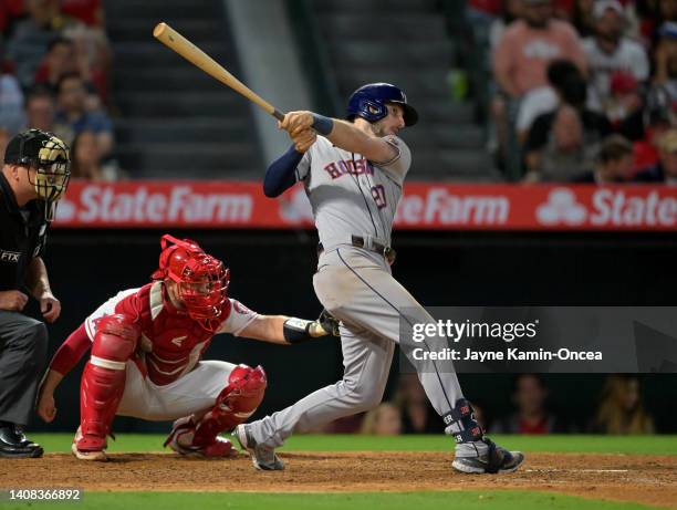 Kyle Tucker of the Houston Astros doubles to score Jose Altuve for the go ahead run in the ninth inning against the Los Angeles Angels at Angel...