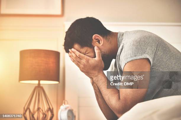 man looking stressed and anxious while suffering from insomnia at home. guy going through a breakup and heartbreak. man feeling depressed and hopeless after a job loss. male waking up in the morning - man with gray hair stock pictures, royalty-free photos & images