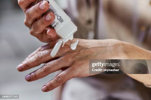 applying hand cream! - creme tube imagens e fotografias de stock