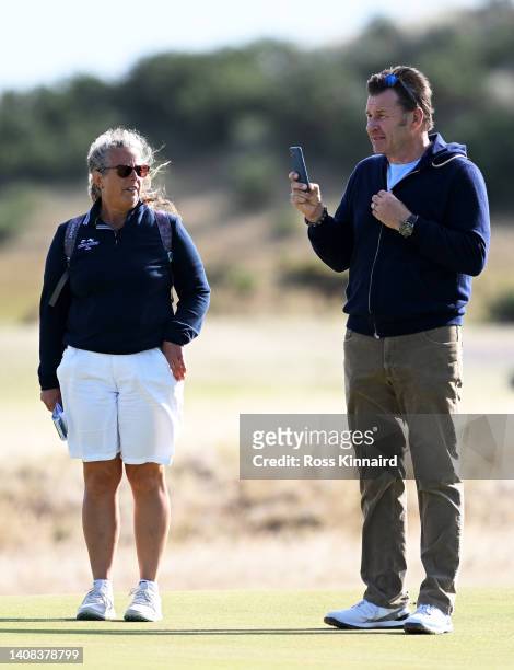 Sir Nick Faldo and Fanny Sunesson make their way around the course during a practice round prior to The 150th Open at St Andrews Old Course on July...