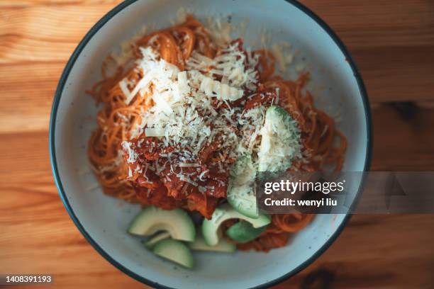 tomato sauce italian spaghetti with salami and avocado - grated stock pictures, royalty-free photos & images