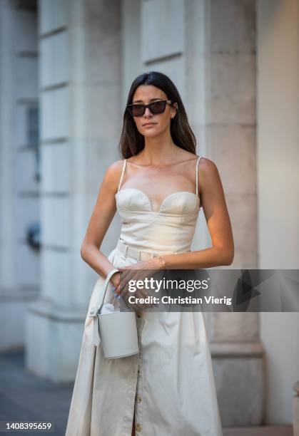 Paula Nata is seen wearing dress Carolina Herrera, bucket bag Adrianne, Hermes shoes on July 12, 2022 in Barcelona, Spain.