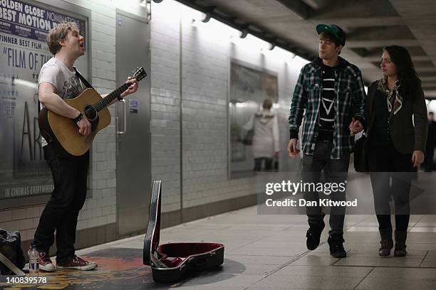 Busker plays at an Underground station on February 28, 2012 in London, England. London's underground rail system, commonly called the tube, is the...